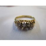 An 18ct gold ring set with five diamonds, 2.35g