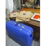 A modern blue Samsonite hard case suitcase, having two wheels