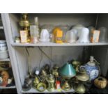A quantity of brass oil l amps and others with various glass shades and smoke funnels, along with
