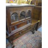 A 20th century oak coffee table with two small drawers, together with a matching oak glazed low