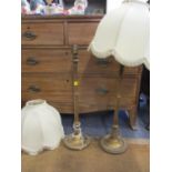 A pair of early 20th century gold painted treen table lamps with cream tasselled shades