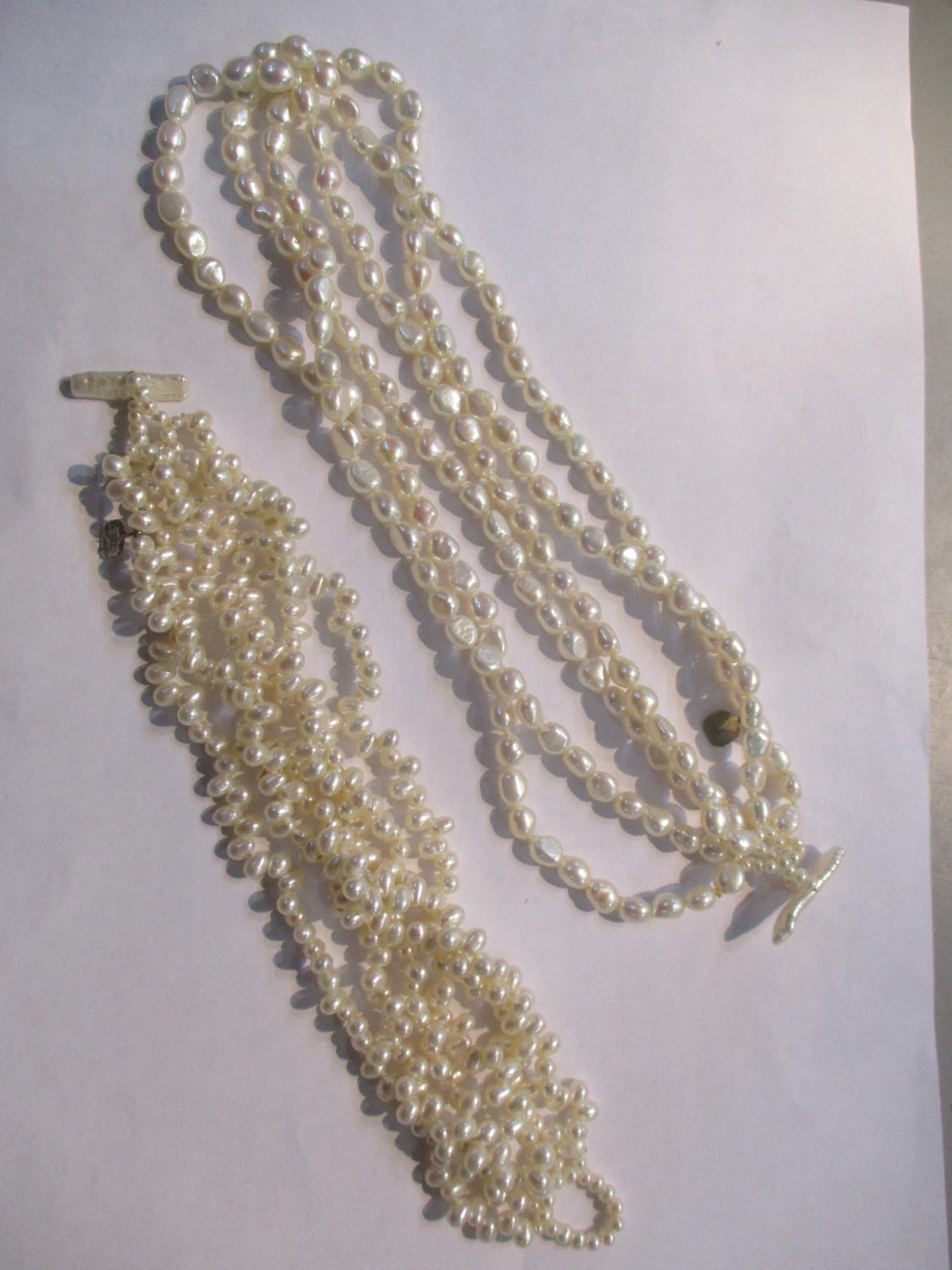 A Biwa pearl three strand necklace and a similar bracelet Location: CAB