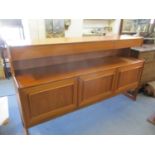 A 1960's McIntosh Forfar teak sideboard having three top drawers one being a cutlery drawer and