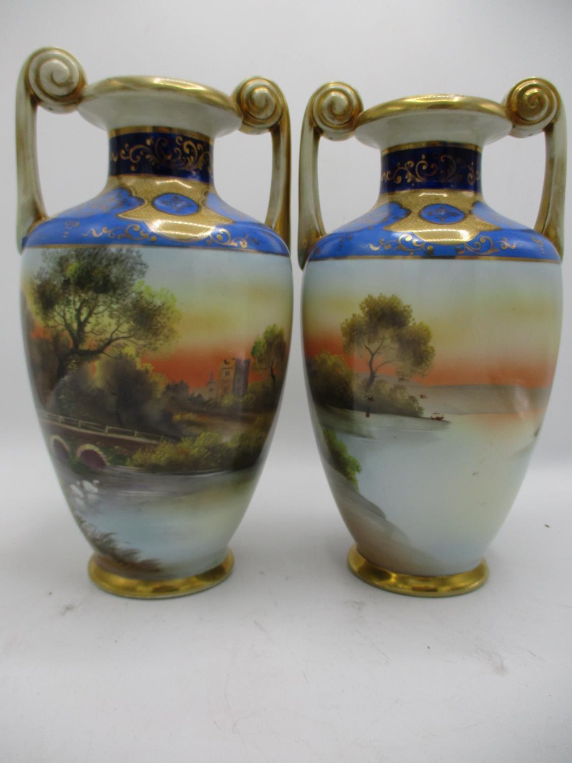 A pair of Japanese Noritake vases of baluster form with twin, spiral handles, decorated with river