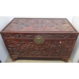 An early 20th century Chinese hardwood chest, the top, front and sides carved with dragons and