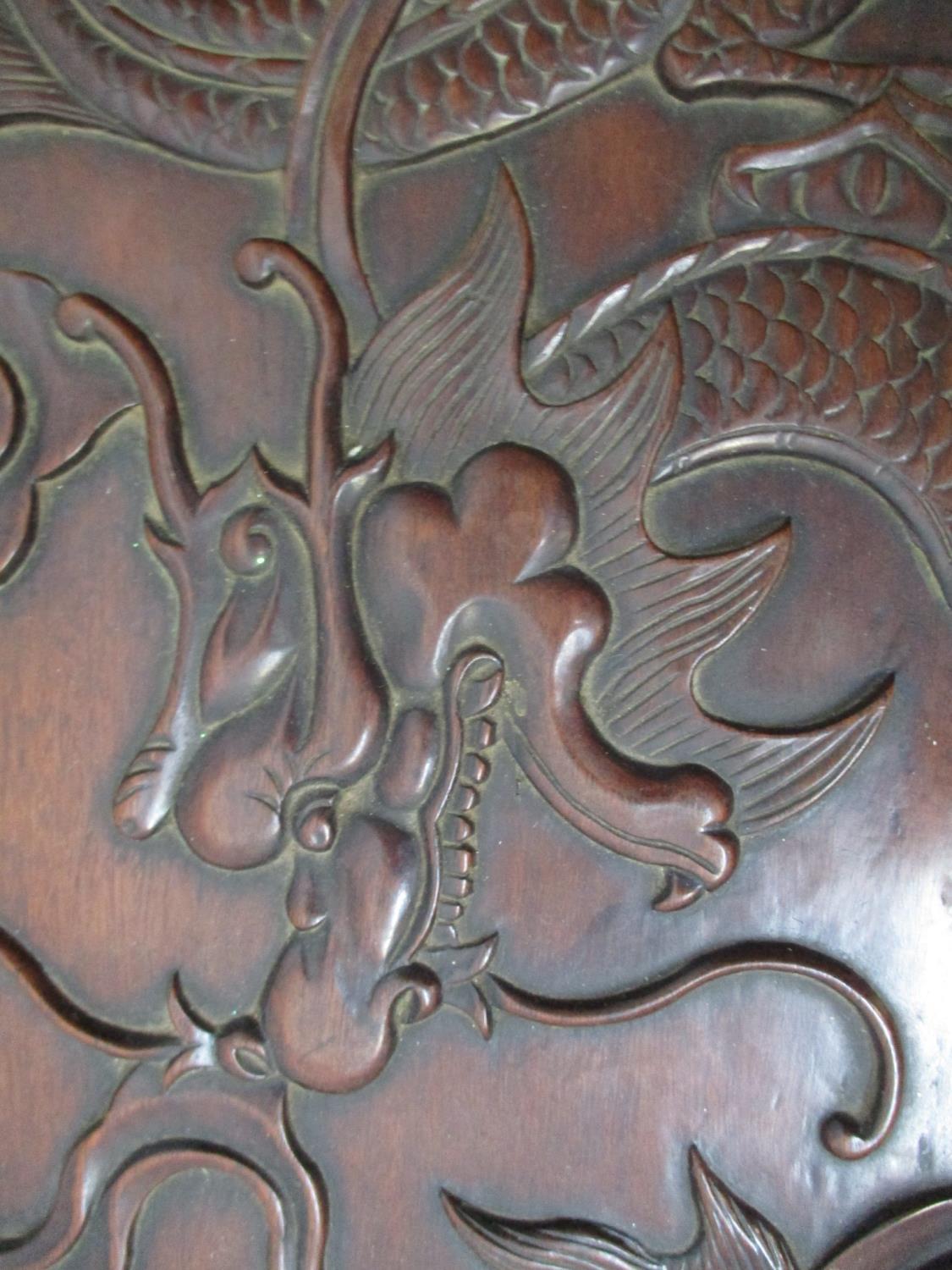 An early 20th century Chinese hardwood chest, the top, front and sides carved with dragons and - Image 6 of 6