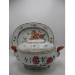 A late 18th century Chinese tureen and cover and a matching meat plate decorated with blossoming