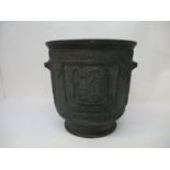 A large Chinese archaic style bronze jardinière, the circular body with carved out cartouches