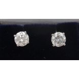 A pair of 18ct white gold solitaire stud earrings, each set with round brilliant cut diamonds, 1.