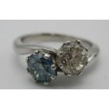 A platinum diamond ring set with a vivid blue diamond, 0.74cts and the other a round brilliant cut