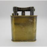 An early 20th century silver plated Dunhill table lighter with engine turned decoration, patent no