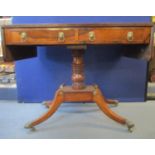 A Regency brass inlaid rosewood sofa table with twin fall flaps and a reeded edge, over a pair of