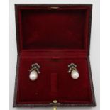 A pair of silver earrings with diamond set bow tops and pearl pendants, boxed