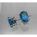 A pair of silver stud earrings set with blue apatites