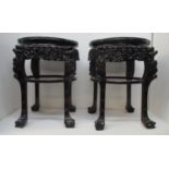 A pair of late 19th century Chinese carved hardwood tables with an inset marble, lobed top, a