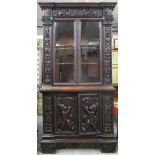 A late 19th century Edwards & Roberts Italianate walnut breakfront bookcase cabinet carved with