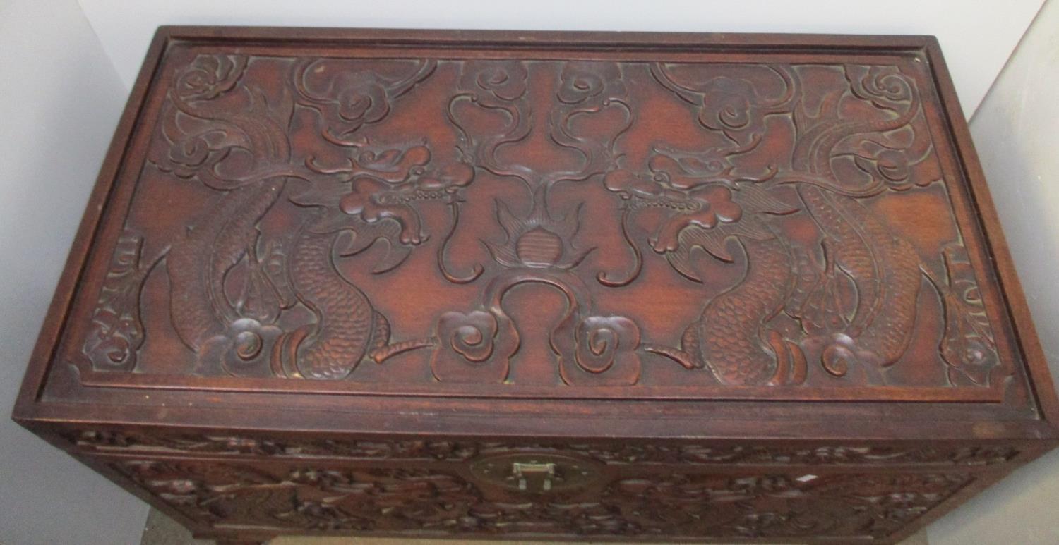 An early 20th century Chinese hardwood chest, the top, front and sides carved with dragons and - Image 2 of 6