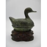 A 20th century Chinese patinated bronze box fashioned as a duck, on a carved hardwood stand, 5 3/4"h
