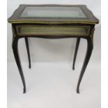 A late 19th century Boulle display table with cast brass mounts, having a hinged bevelled glazed,