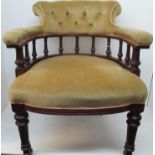 An early 20th century mahogany library chair with a button upholstered crest, level arms and turned,