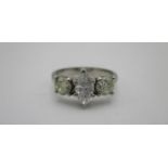 A platinum three stone diamond ring set with a marquise cut stone, 0.53ct colour D, clarity VVSI