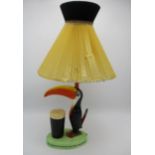A Guinness advertising table lamp by Carlton Ware, fashioned as a toucan by a pint of Guinness,