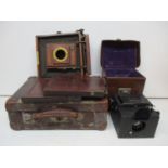 An Ensign Focal Plane Roll Film Reflex camera in a brown leather carrying case and a J Lancaster &