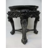 A late 19th century Chinese hardwood stand with a lobed inset mottled marble top and bead edge, over