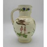 A late 19th century Wedgwood cream glazed jug, of ovoid form, mask spout and splayed foot, decorated
