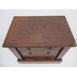 A late Victorian string inlaid, burr walnut table top Wellington chest with crossbanded edges and