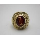 A 10ct gold gents American collage signet ring set with a red cabochon inlaid with initial MKA and