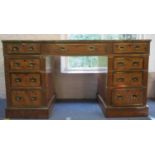 A late 19th/early 20th century satinwood military style, twin pedestal desk with brass banding to