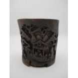 A 19th century Chinese carved bamboo brush pot decorated with figures in a boat, with mountains