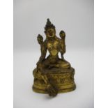 A Sino Tibetan gilt bronze statue of Tara Bodhisattva seated in Lalit asana, on an oval double lotus