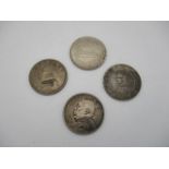 Four coins comprising of a Birth of Republic of China memento, silver dollars, a middle eastern coin
