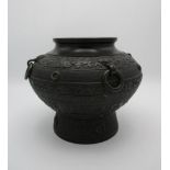 A 19th/20th century Chinese bronze vase of baluster form decorated with bands of pattern and four
