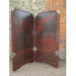 An early 20th century Chinese lacquered two fold screen, with brass corners and mounts, decorated