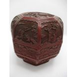 A large 19th century Chinese cinnabar box of octagonal form, the domed lid decorated with panels