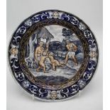 An 18th/19th century French enamel plate decorated to the centre with an allegorical scene and masks
