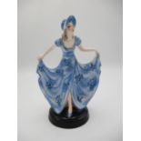 A Goldscheider figure designed by Stephen Dakon, a dancer wearing a bonnet and blue floral dress, on