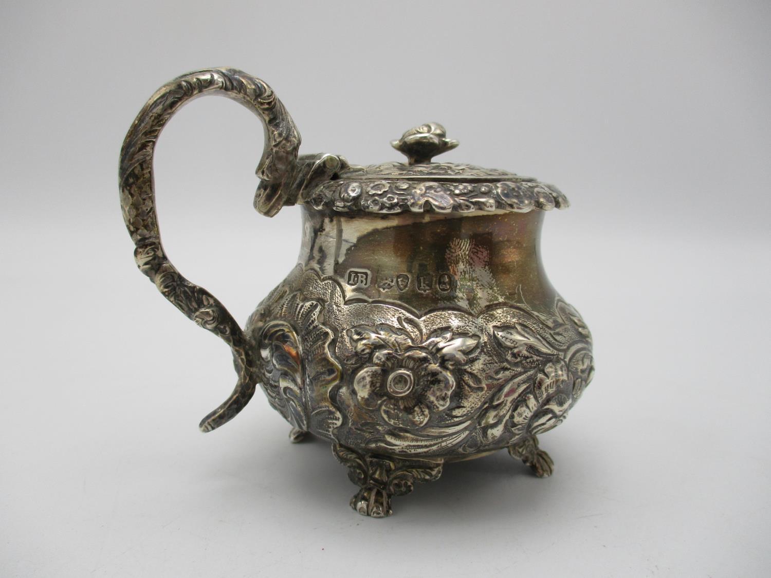 A George IV silver mustard pot by Joseph Biggs, London 1825, of bulbous form with embossed foliage - Image 2 of 4