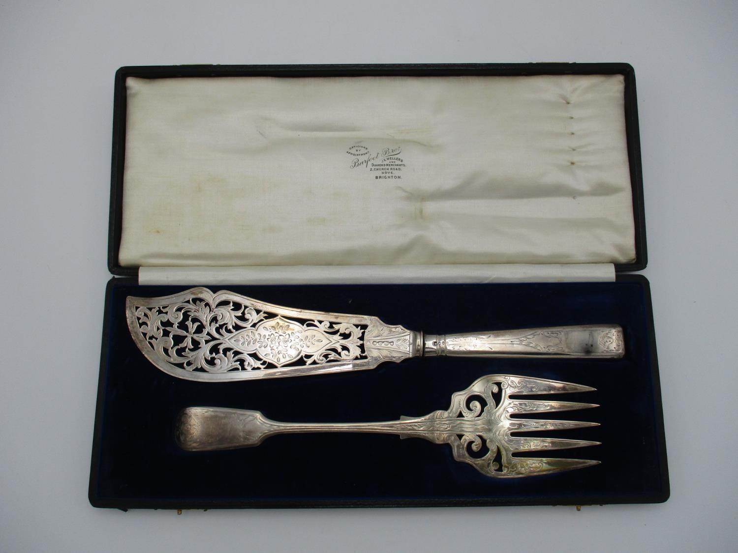 A cased near pair of Victorian fish servers, by Mappin Brothers and Henry John Lias & James