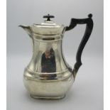 A George V silver coffee pot by William Hutton & Sons, Sheffield 1911, with ebonised handle and