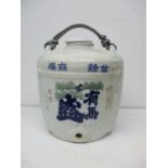 A 20th century Japanese ceramics sake barrel, modelled with basket and rope effect lid, the body