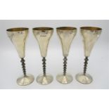 A set of four Elizabeth II silver wine goblets by Stuart Devlin, London 1979, with hammered