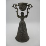 A large Continental silver plated wager cup, cast as a lady holding aloft a swivelling cup,