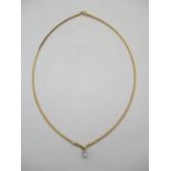 An 18ct yellow gold rope style necklace with a white gold pendant set with an emerald cut diamond
