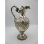 A Victorian silver wine jug by Martin Hall, Sheffield 1860, with scroll handle ending in a lion