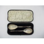 A cased pair of Victorian silver serving spoons by William Hutton & Sons, London 1894, with shell