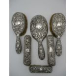 A group of English silver mounted dressing table brushes, all mostly dated between 1897 and 1901,